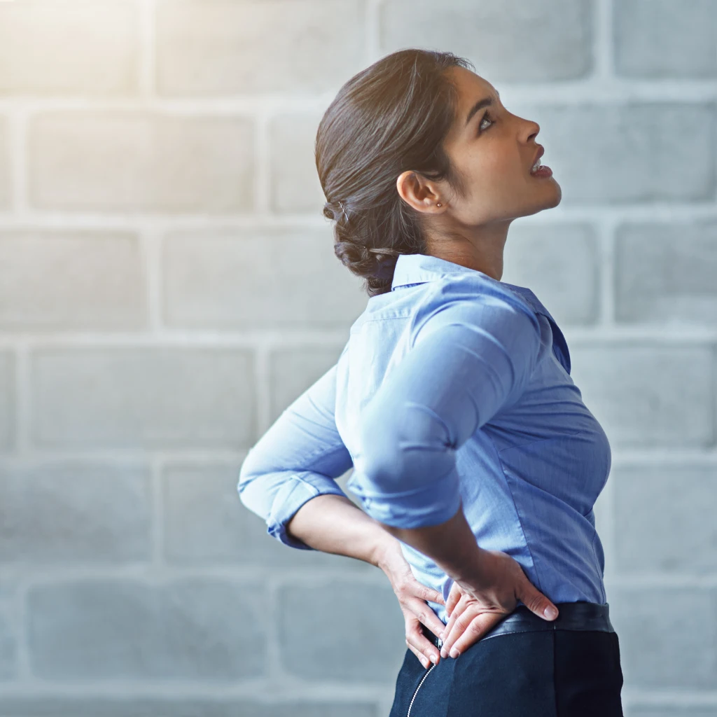 back-pain-office-stress-business-woman-with-muscle-injury-health-risk-fatigue-mockup-wall-uncomfortable-female-worker-spine-problem-bad-posture-injured-body-scoliosis-joint 1