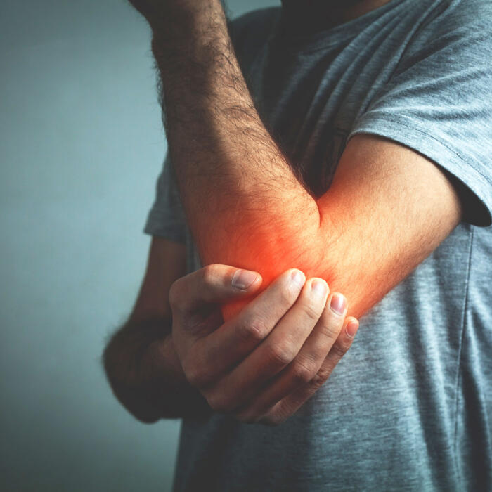Woman gripping her painful ankle with red inflammation highlight on the joint Man holding his elbow with red inflammation highlight indicating joint pain